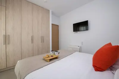 a bedroom with a white bed with a wooden tray on it at A Heaven View Park Hideaway - Chania Nest in Chania Town