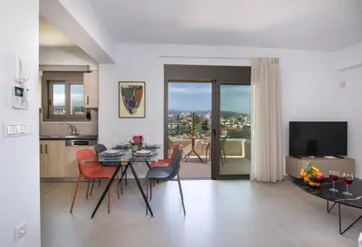 a kitchen and living room with a table and chairs at A Heaven View Park Hideaway - Chania Nest in Chania Town