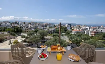 a table with bread and orange juice on a balcony at A Heaven View Park Hideaway - Chania Nest in Chania Town