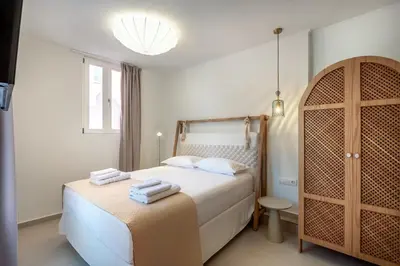 a bedroom with a bed with towels on it at On Luxury Chania in Chania Town
