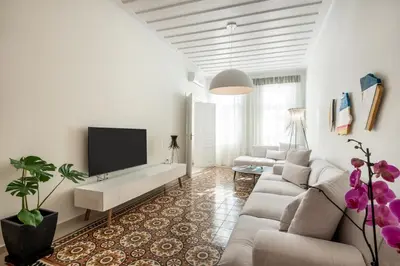 a living room with a couch and a flat screen tv at On Luxury Chania in Chania Town