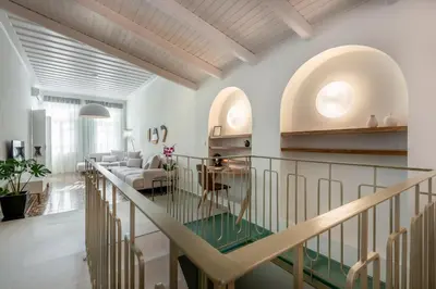 a staircase in a living room with a glass table at On Luxury Chania in Chania Town