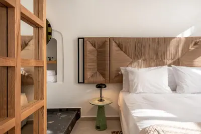 a bedroom with a bed with a wooden headboard at On Luxury Chania in Chania Town
