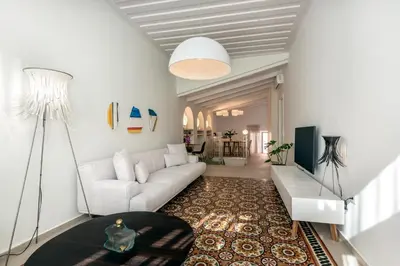a living room with a white couch and a table at On Luxury Chania in Chania Town