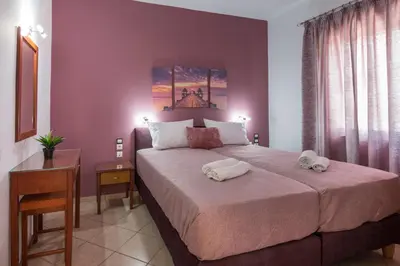 a bedroom with a large bed with towels on it at MARIHELEN APARTEMENTS in Kamisianá