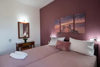 a bedroom with a bed with two towels on it at MARIHELEN APARTEMENTS in Kamisianá