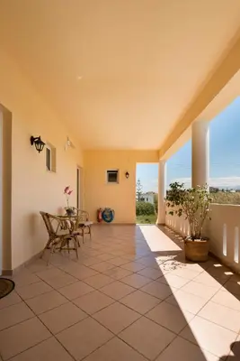 an empty house with a terrace with chairs and a table at MARIHELEN APARTEMENTS in Kamisianá