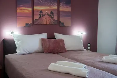 a bedroom with a bed with two towels on it at MARIHELEN APARTEMENTS in Kamisianá