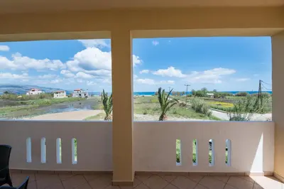 a view of the beach from a room with windows at MARIHELEN APARTEMENTS in Kamisianá