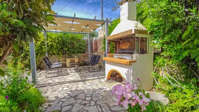 a patio with an outdoor oven in a garden at Lemon Tree Villa with Private Pool and Starlink Internet in Frés