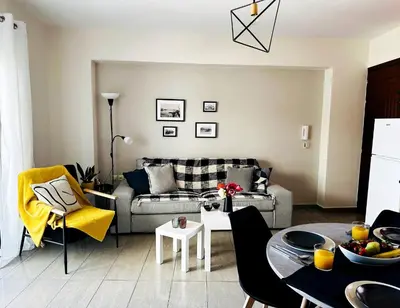 a living room with a couch and a table at Cozy Snuggle- 2min To Beach, 6min Walk To Old Town in Chania Town
