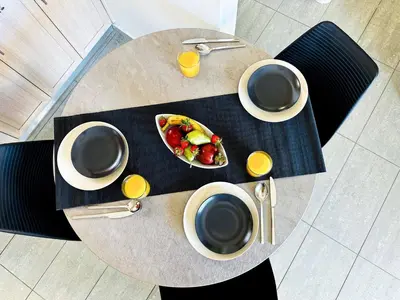 a table with a bowl of fruit and two cups of coffee at Cozy Snuggle- 2min To Beach, 6min Walk To Old Town in Chania Town