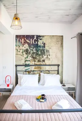 a bedroom with a large bed with a brick wall at Secret Loft, 2min Walk From The Beach, High Tech in Chania Town