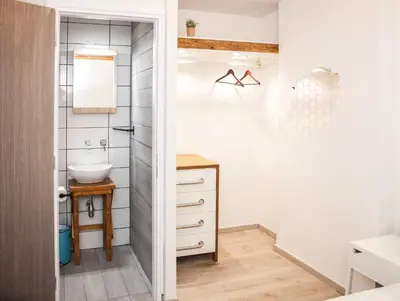 a small bathroom with a sink and a mirror at Secret Loft, 2min Walk From The Beach, High Tech in Chania Town