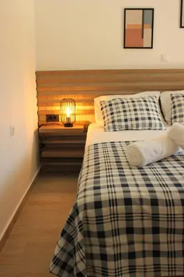 a bedroom with two beds and a lamp on a table at Phaedra House For Relaxing Holidays Near Platanias in Vlakheronítissa