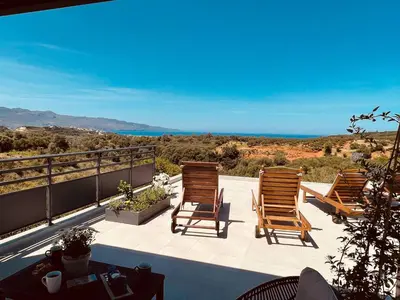 a group of chairs sitting on a patio at Phaedra House For Relaxing Holidays Near Platanias in Vlakheronítissa
