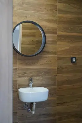 a bathroom with a sink and a mirror on a wall at The Suite Spot - At The Heart Of The Old Town in Chania Town