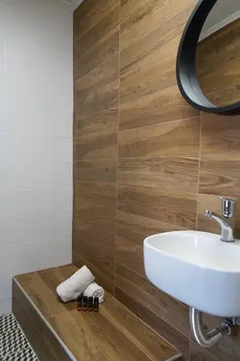 a bathroom with a white sink and a mirror at The Suite Spot - At The Heart Of The Old Town in Chania Town