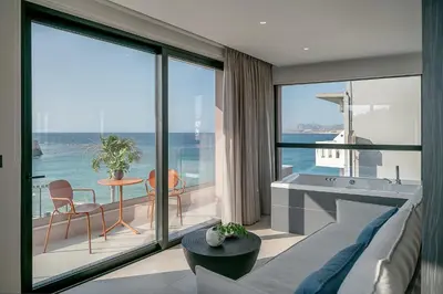 a living room with a couch and a view of the ocean at Theta Boutique Hotel in Chania Town