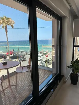 a room with a balcony with a view of the ocean at Theta Boutique Hotel in Chania Town
