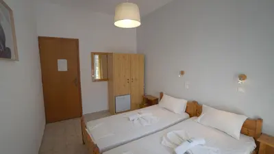 a bedroom with two beds with towels on them at Ilingas Hotel in Khóra Sfakíon