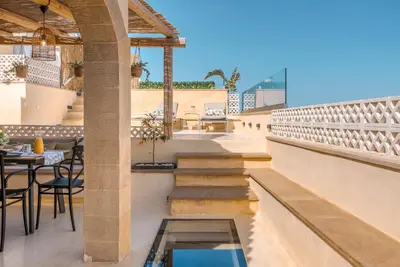a patio with a table and chairs on a building at Disegno Villa - Rooftop Pool in Kolymvari