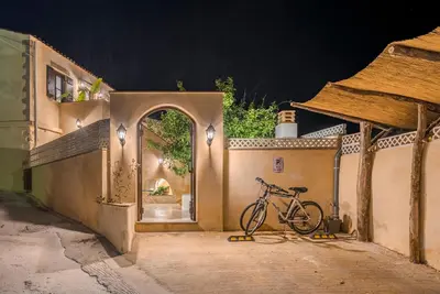 a bike parked outside of a building at night at Disegno Villa - Rooftop Pool in Kolymvari