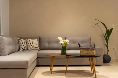 a living room with a couch and a table with flowers at Ros Solis Luxure House in Chania Town