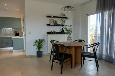 a kitchen and dining room with a table and chairs at Ros Solis Luxure House in Chania Town