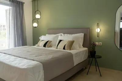 a bedroom with a bed with white sheets and pillows at Ros Solis Luxure House in Chania Town