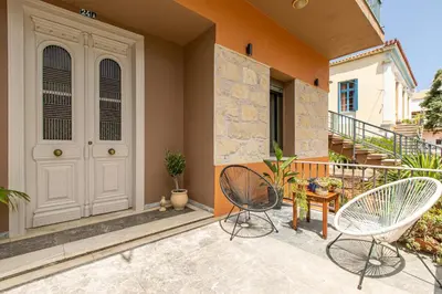 a patio with two chairs and a table at Casa di Batsi in Chania Town