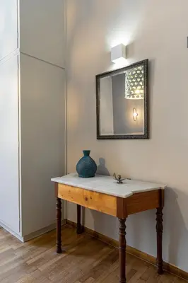 a table with a blue vase on it in a room at Casa di Batsi in Chania Town
