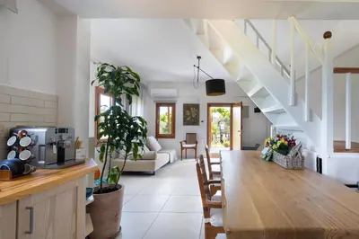 a dining room and living room with a wooden table at Eliva house in Chania Town