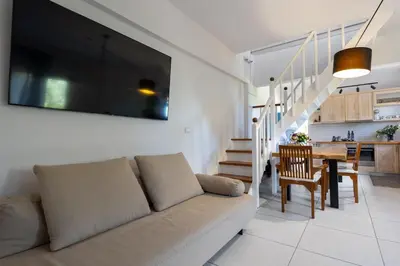 a living room with a couch and a dining room at Eliva house in Chania Town