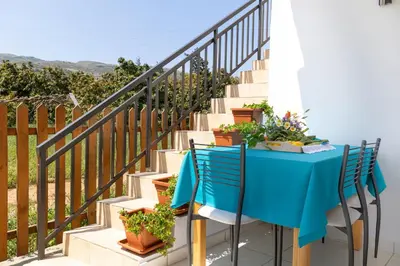 a table and chairs with plants on a staircase at Eliva house in Chania Town