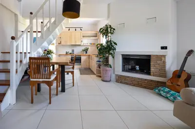 a kitchen and dining room with a table and a fireplace at Eliva house in Chania Town
