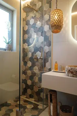 a shower with a glass door next to a sink at L A Boutique Suites with Private Hot Tub in Kalathas