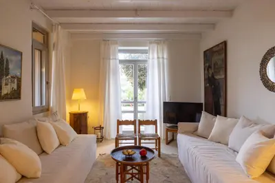a living room with a white couch and a table at Rimondi Residences Chania in Chania Town