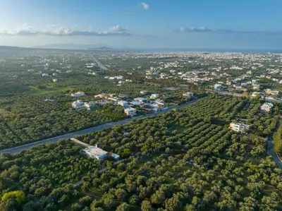 an aerial view of a city with trees and a river at Rimondi Residences Chania in Chania Town