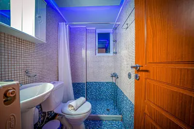 a bathroom with a toilet and a sink and a shower at Villa Lima Pool & Jacuzzi Chania in Vamos