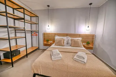 a bedroom with a bed with two towels on it at Haroto Home Residence in Plokamianá