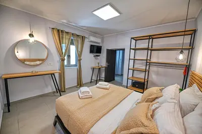 a bedroom with a bed and a mirror at Haroto Home Residence in Plokamianá
