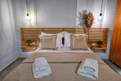a bedroom with a large bed with two towels at Haroto Home Residence in Plokamianá