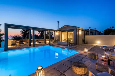 a swimming pool in the backyard of a house at Natura Hill Villa IV Sea View in Kounoupidhianá