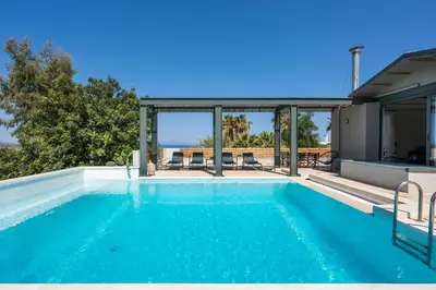a swimming pool in the backyard of a house at Natura Hill Villa IV Sea View in Kounoupidhianá