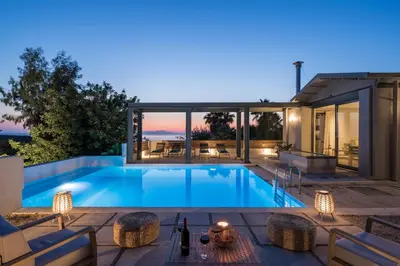 a swimming pool in the backyard of a house at Natura Hill Villa IV Sea View in Kounoupidhianá