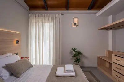 a bedroom with a bed with two towels on it at Natura Hill Villa IV Sea View in Kounoupidhianá
