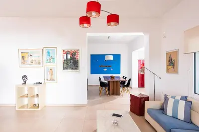 a living room with a blue couch and a table at Villa Kiara in Tersanas