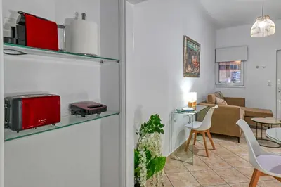 a living room with a kitchen and a living room with a table at Hope apt - 5min to Falassarna Bch in Kissamos