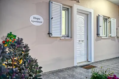 a house with a christmas tree in front of a door at Hope apt - 5min to Falassarna Bch in Kissamos